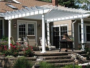 Pergola on a raised patio with landscaping and planter boxes